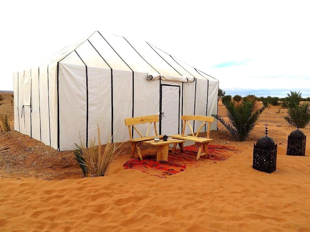 The tents of Sundrift Luxury Camp seen from the dunes